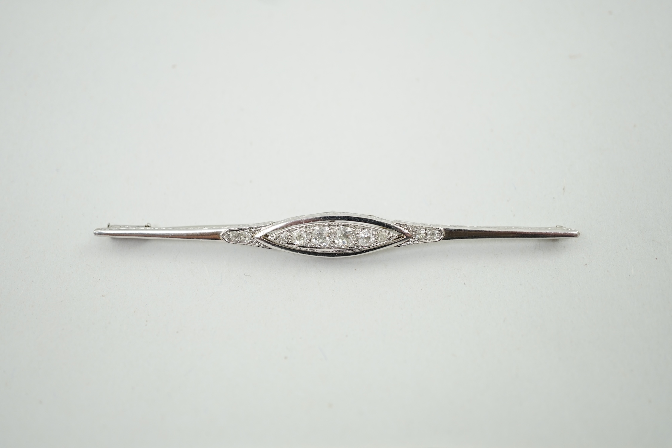 An early 20th century platinum? and diamond cluster set bar brooch